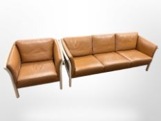 A 20th-century Danish tan leather three-seater settee with matching armchair,