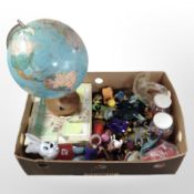 A globe together with various toys and figures, two jars of craft beads, etc.