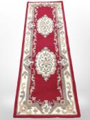 A machine-made Chinese runner, 204cm x 67cm.