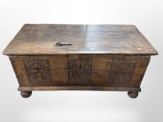 A 19th-century Scandinavian oak blanket chest on bun feet, with key,