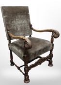 A continental heavily carved oak armchair in brass studded upholstery, width 66cm.