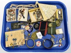 An antique cuff bangle, together with a group of costume jewellery, badges, Scottish brooch, fan,