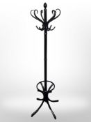 An ebonised hat and coat stand, height 186cm.