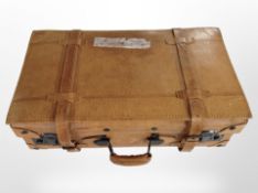 A stitched tan leather luggage case.