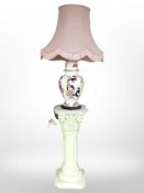 A reproduction classical-style pedestal, together with a Mason's table lamp.