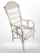 A painted wicker garden armchair.