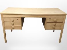 A 20th-century Danish oak twin pedestal writing desk fitted six drawers,