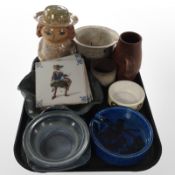 A group of continental studio pottery wares including shallow bowls, figural money box, Delft tiles,