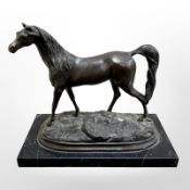 A bronze figure of a horse, on black marble plinth, length 25cm.
