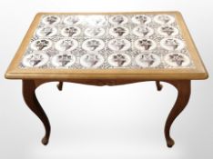 A Danish blonde oak tile-topped occasional table, width 89cm.