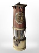 A brass and copper Eccles protector miner's lamp.