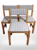A set of six pine chairs in striped grey upholstery.