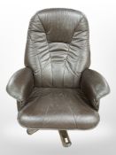A Danish brown leather swivel chair