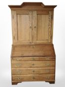 A 19th-century continental oak secretaire bureau, 116cm wide x 60cm deep x 214cm high.