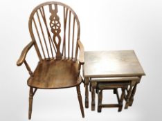 A beech wheel back armchair, together with a nest of three tables.