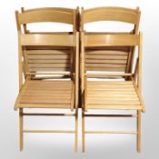 A set of six oak-effect folding garden chairs.