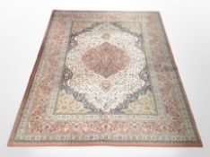 A machine-made rug of Persian design, 240cm x 170cm.