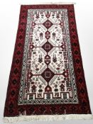 An Afghan/Caucasian rug, 205cm x 100cm.