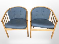 A pair of Danish bentwood armchairs with blue cushions.