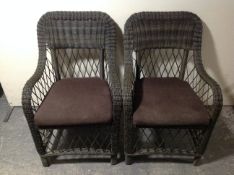 A set of six wicker garden armchairs.