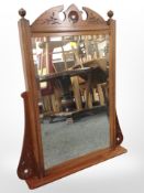 A carved mahogany bevelled glass wall mirror, width 60cm.