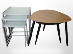 A nest of two teak-effect ebonised tripod tables,