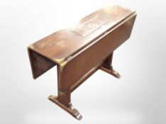 A mahogany brass-mounted drop-leaf storage dining table, length 107cm.