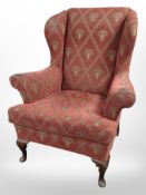 A reproduction wingback armchair in the Georgian style, width 84cm.