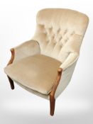 A contemporary armchair in buttoned fabric.