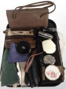 A group of lady's leather handbags, compacts, gloves, etc.
