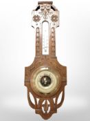 A carved oak barometer/thermometer, length 53cm.