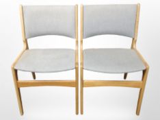 A pair of contemporary Danish oak-framed chairs in grey upholstery.