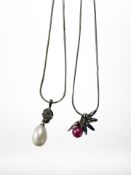 A faux pearl pendant on silver chain,