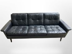A 20th-century Danish black leather three-piece lounge suite comprising of three-seater settee,