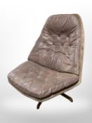 A Danish brown leather swivel relaxer chair.