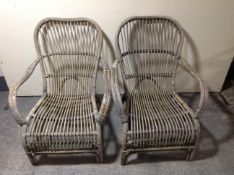 A pair of weathered bamboo garden armchairs.