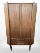 A 20th-century Danish teak corner cabinet, height 144cm.