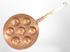 A vintage Scandinavian copper Aebleskiver pan, length 62cm.