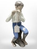 A Bing & Grøndahl figure of a boy playing the flute, height 29cm.