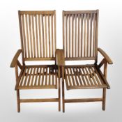 A set of four folding teak garden armchairs.