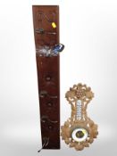 A five-hook coat rack, together with a heavily carved oak barometer.