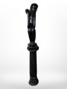 An African ebonised statue, together with a pedestal, overall height 174cm.