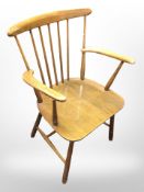 A stained beech spindle back armchair.