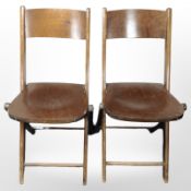 A pair of 20th-century Scandinavian curved and laminated beech folding chairs.