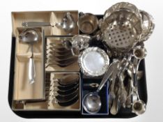 A collection of silver-plated cutlery, shallow dishes, candle stand, etc., some pieces boxed.