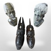 A pair of African carved soapstone busts of a man and a woman, height 17cm,