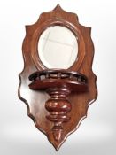 A reproduction mahogany wall mirror with galleried shelf, length 60cm.