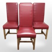 A set of four contemporary stitched red leather highback dining chairs.