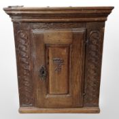 An 18th-century Scandinavian carved oak single-door cabinet, 58cm wide x 40cm deep x 67cm high.