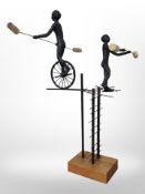 A contemporary metal sculpture of two trapeze artists, height 65cm.